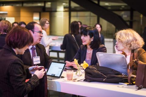 People speaking around a table at an event